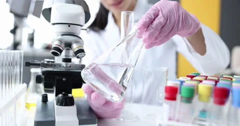 Scientist in laboratory examines transparent liquid closeup Stock Footage 169841798