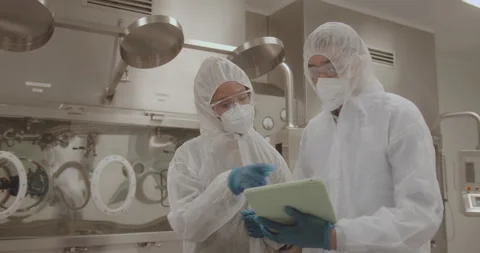 Scientist in Laboratory looking at test results on Digital Tablet Stock Footage 196172124