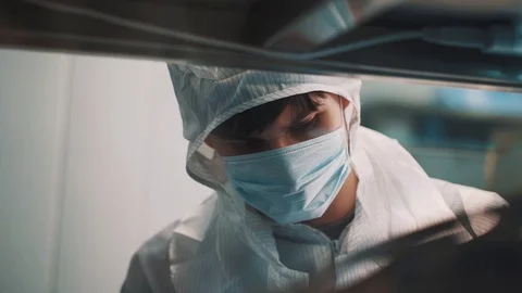 Scientist at laboratory making experiment wiping glass with cotton swab Stock Footage