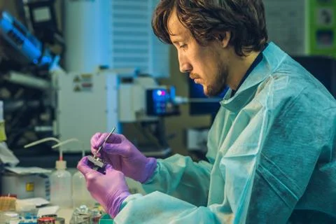 Scientist in a laboratory prepare a sample for an elecron microscopic investi Stock Photos