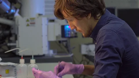 Scientist in a laboratory prepares samples for electron microscopy investigation Video stock 77978667