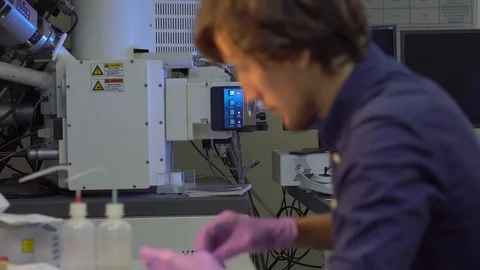 Scientist in a laboratory prepares samples for electron microscopy investigation Stock Footage