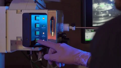 Scientist in a laboratory put samples into electron microscope for investigation Stock Footage 77980670