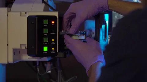 Scientist in a laboratory put samples into electron microscope for investigation Video stock 77980896