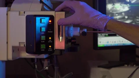 Scientist in a laboratory put samples into electron microscope for investigation Stock Footage 77981674