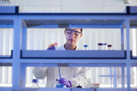 Scientist in laboratory using electronic pipette Stock Photos