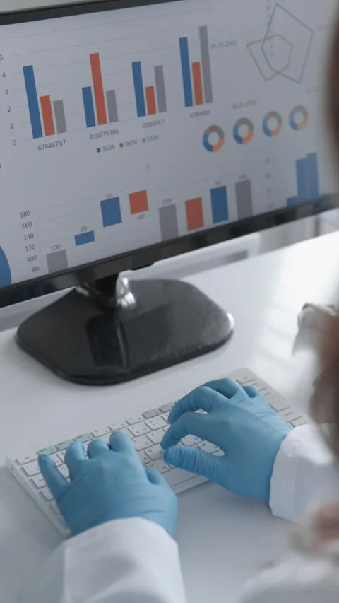 A scientist in the laboratory utilizes technology to analyze data by creating Stock Footage 280378812