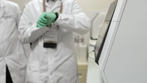 A scientist in a laboratory works with a modern amplifier for real-time PCR. Stock Footage 313169934