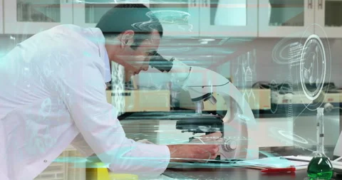 Scientist leaning over microscope in science lab viewing holographic molecular Vidéo 308659470