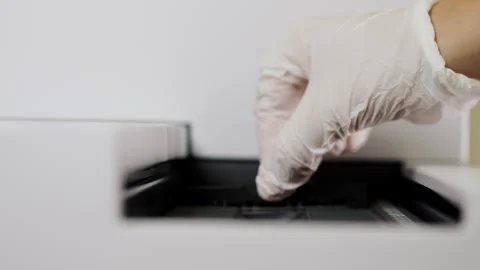 A scientist loads samples into a scanner for microarray analysis. Stock Footage 294564081