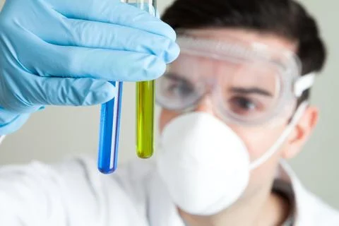 Scientist looking at liquid in test tubes Stock Photos