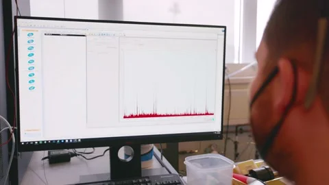 Scientist looking at mass spectrometer results on a screen Stock Footage 231858585