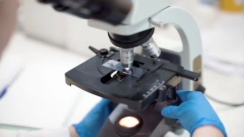 Scientist looking into microscope. Close up shot in lab. Video stock 110810615