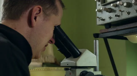 Scientist looking into a microscope Stock Footage 61759661