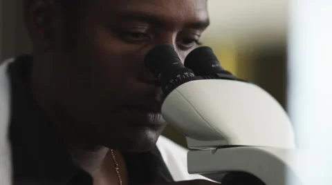 Scientist Looking in Microscope Stock Footage 62875884