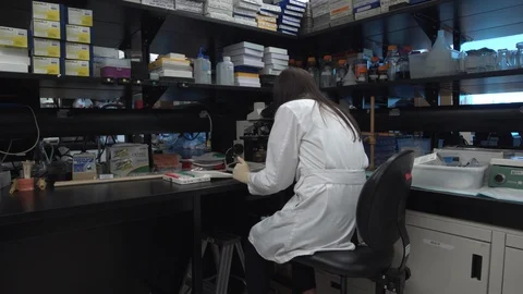 Scientist looking in a microscope Stock Footage 106900269