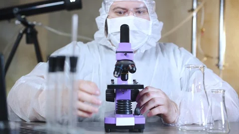 Scientist looking into a microscope in laboratory. Bio lab research. 库存影片 122763165