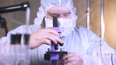 Scientist looking into a microscope in laboratory. Bio lab research. Stock-Footage 122763466