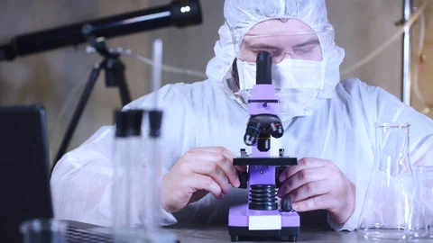 Scientist looking into a microscope in laboratory. Bio lab research. 스톡 동영상 122763599