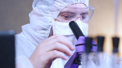 Scientist looking into a microscope in laboratory. Bio lab research. 動画素材 122763822