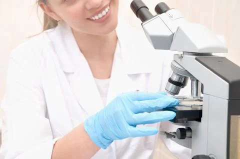 Scientist looking into a microscope in a laboratory Stock Photos