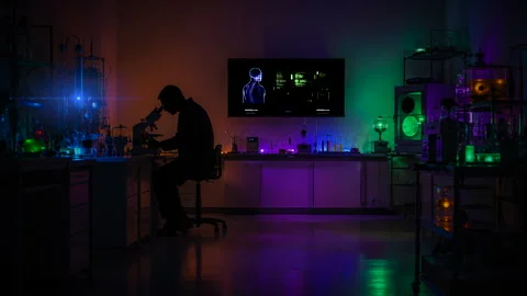Scientist looking into microscope long shot science setting Stock Footage 339631051