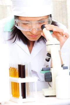 Scientist looking into microscope Stock Photos