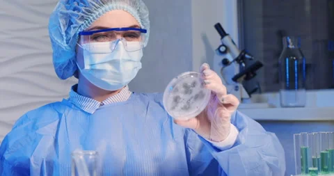 Scientist looking on Petri dish with mold experiment with vaccine Stock Footage 152243929