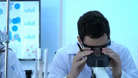 Scientist is looking through microscope. Stock Footage 106668000