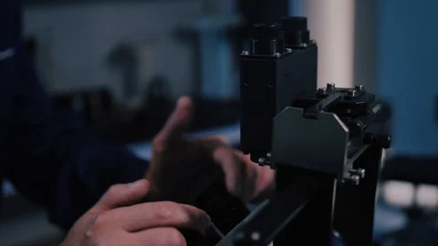 Scientist looking through a microscope in a laboratory Stock Footage 104924429