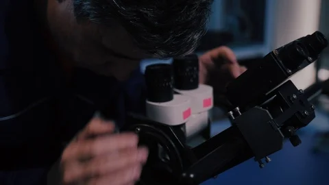 Scientist looking through a microscope in a laboratory Stock-Footage 104924475