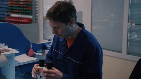 Scientist looking through a microscope in a laboratory Stock Footage 104924580