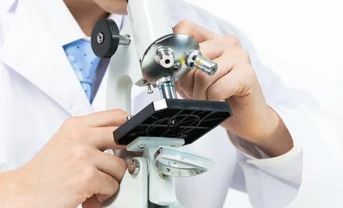 Scientist looking through microscope in laboratory Stock Photos