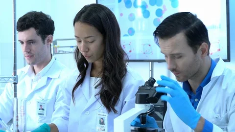 Scientist is looking through microscope in modern laboratory or medical center. Stock Footage 106666563
