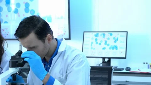 Scientist is looking through microscope in modern laboratory or medical center. Stock-Footage 106666742
