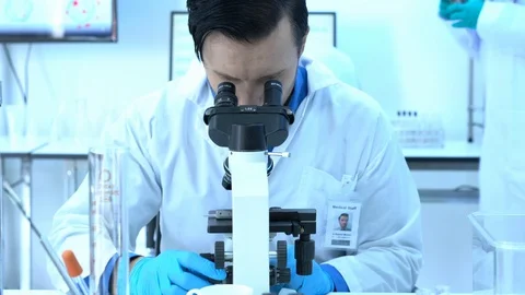 Scientist is looking through microscope in modern laboratory or medical center. Stock-Footage 106666969
