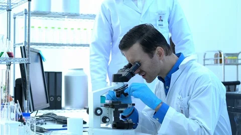 Scientist is looking through microscope in modern laboratory or medical center. Stock-Footage 106667095