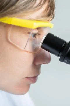 Scientist looking through a microscope Stock Photos