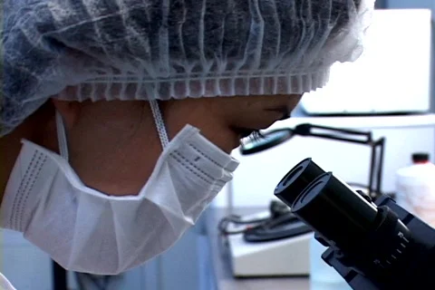 Scientist  looking trought the microscope  스톡 동영상 146765