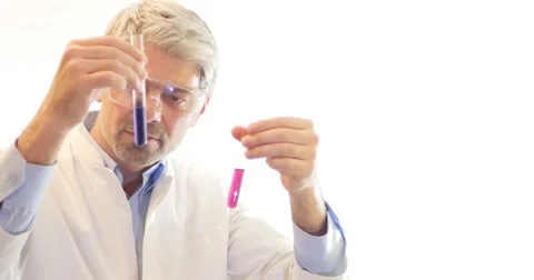 A scientist looking into two test tubes and shows on a white wall Stock Footage 48968631