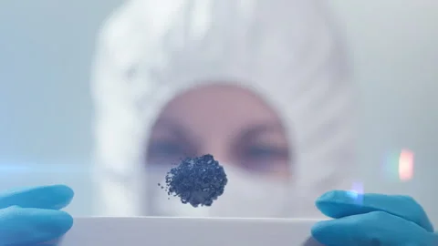 A scientist looks at a levitating black substance. the concept of the develop Stock-Footage 161639554
