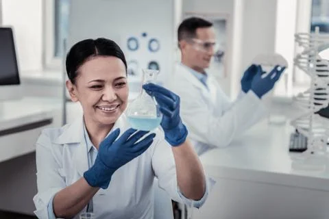 Scientist making the experiment with the flask Stock Photos