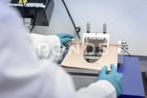 Scientist Making Lithium Ion Battery Samples In Battery Research Facility, Close