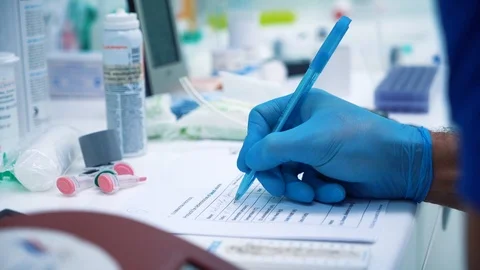 Scientist making notes while working in his lab. genetic biohacking research Stockbeeldmateriaal 121270578