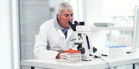 Scientist, man and experiment in lab with microscope, sample inspection and.. Stock Photos