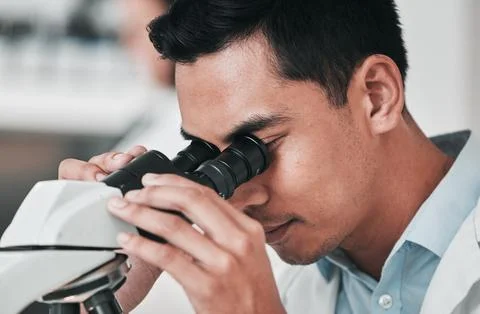 Scientist, man and microscope in laboratory research, DNA analysis and Stock Photos