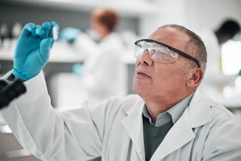 Scientist, man and microscope slide in research, vaccine analysis or data in Stock Photos
