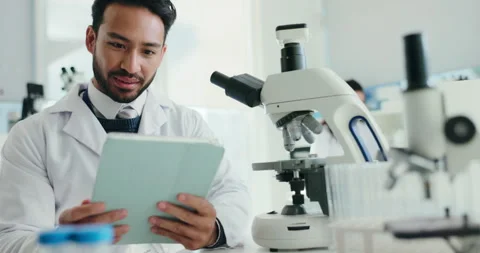 Scientist, man and microscope with tablet for report, breakthrough or medical Stock Footage 310796191