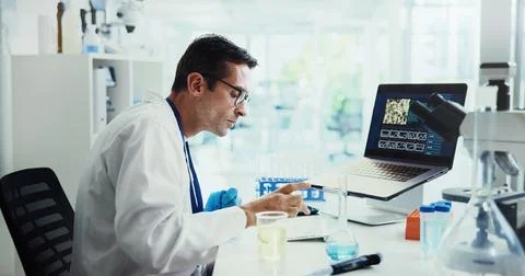 Scientist, man and typing by computer in lab for medical research with feedback Stock Photos