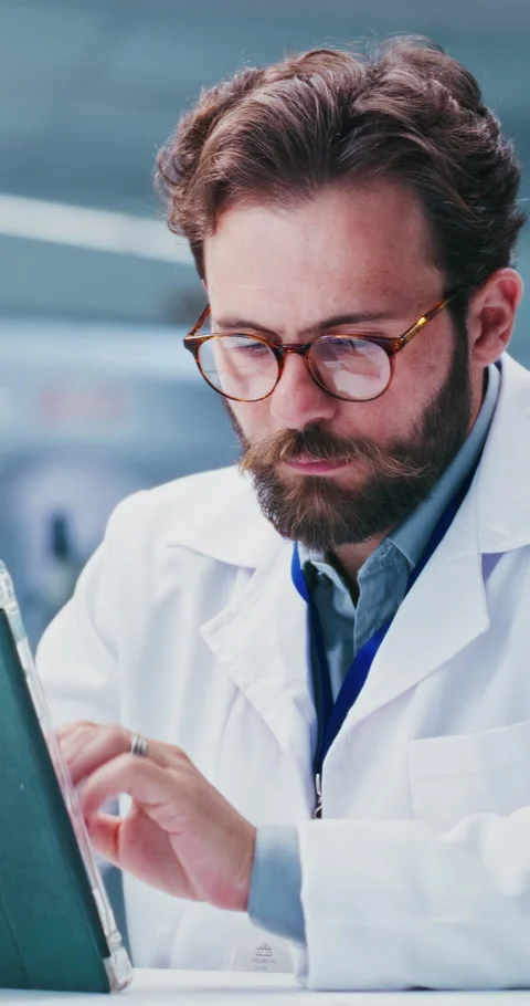 Scientist, man and typing in lab with tablet, test results and reading report Video stock 331519286